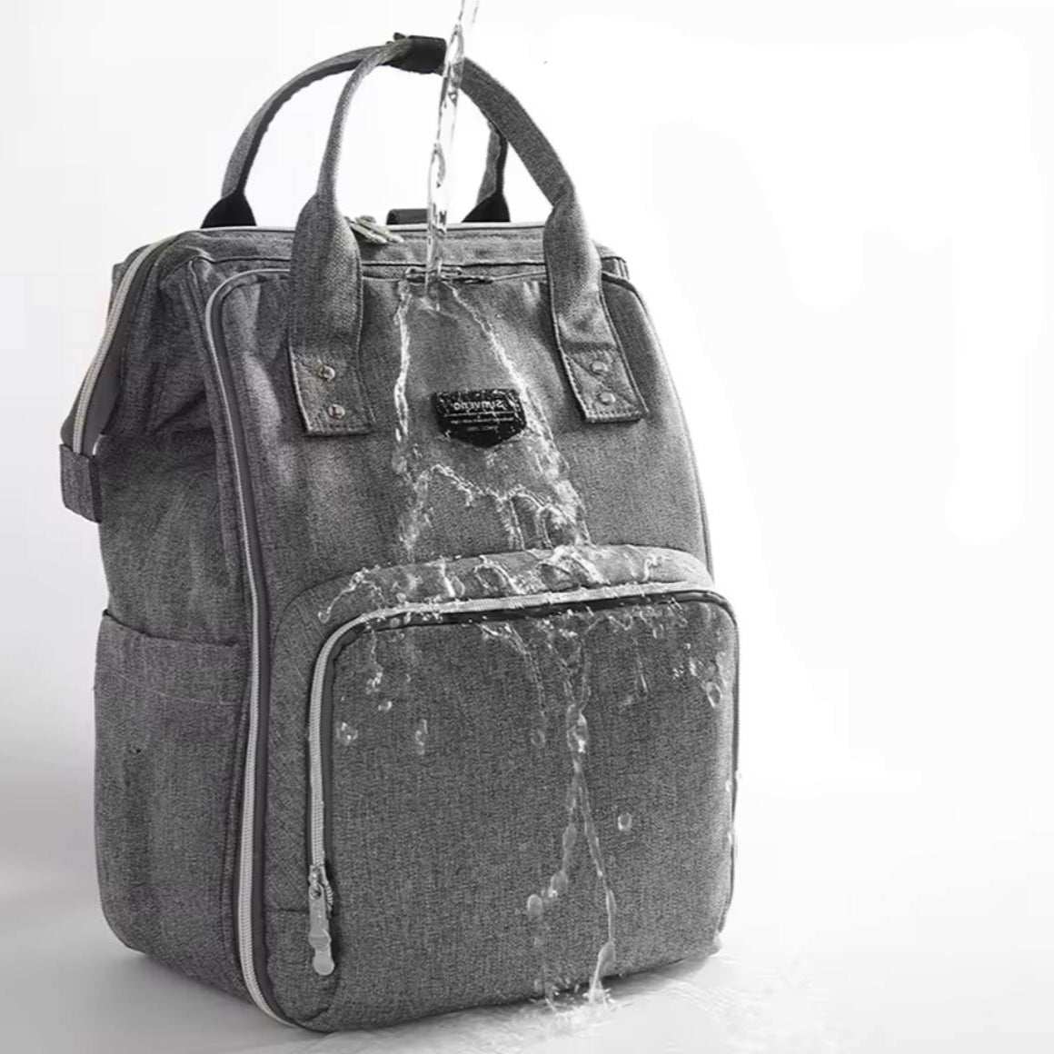 Sac à dos pratique gris en tissu, résistant à l’eau, avec grande poche frontale et poignées renforcées